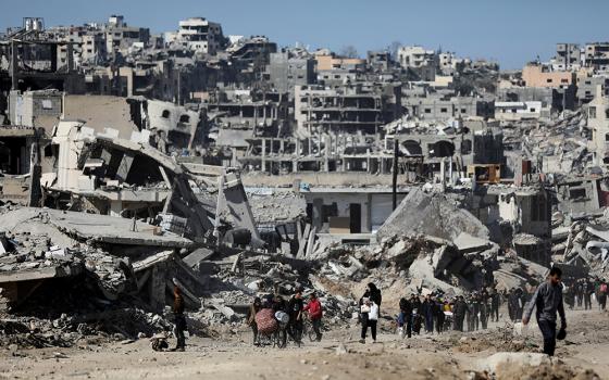 Palestinians make their way past the rubble of destroyed houses and buildings in Jabalia in the northern Gaza Strip, Jan. 21, 2025, following a ceasefire between Israel and Hamas reached Jan. 17. (OSV News/Reuters/Dawoud Abu Alkas)